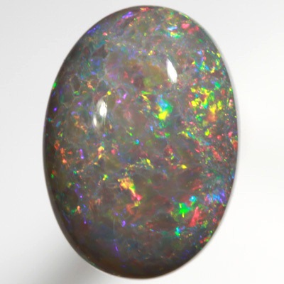SOLID SEMI BLACK OPAL Bright red and green floats over a beautiful rare purple mauve SEE VIDEO